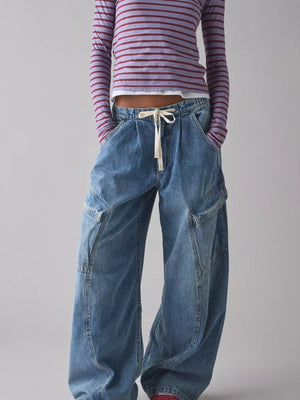 Dusty blue denim cargo jeans with drawstring waist and utility pockets.