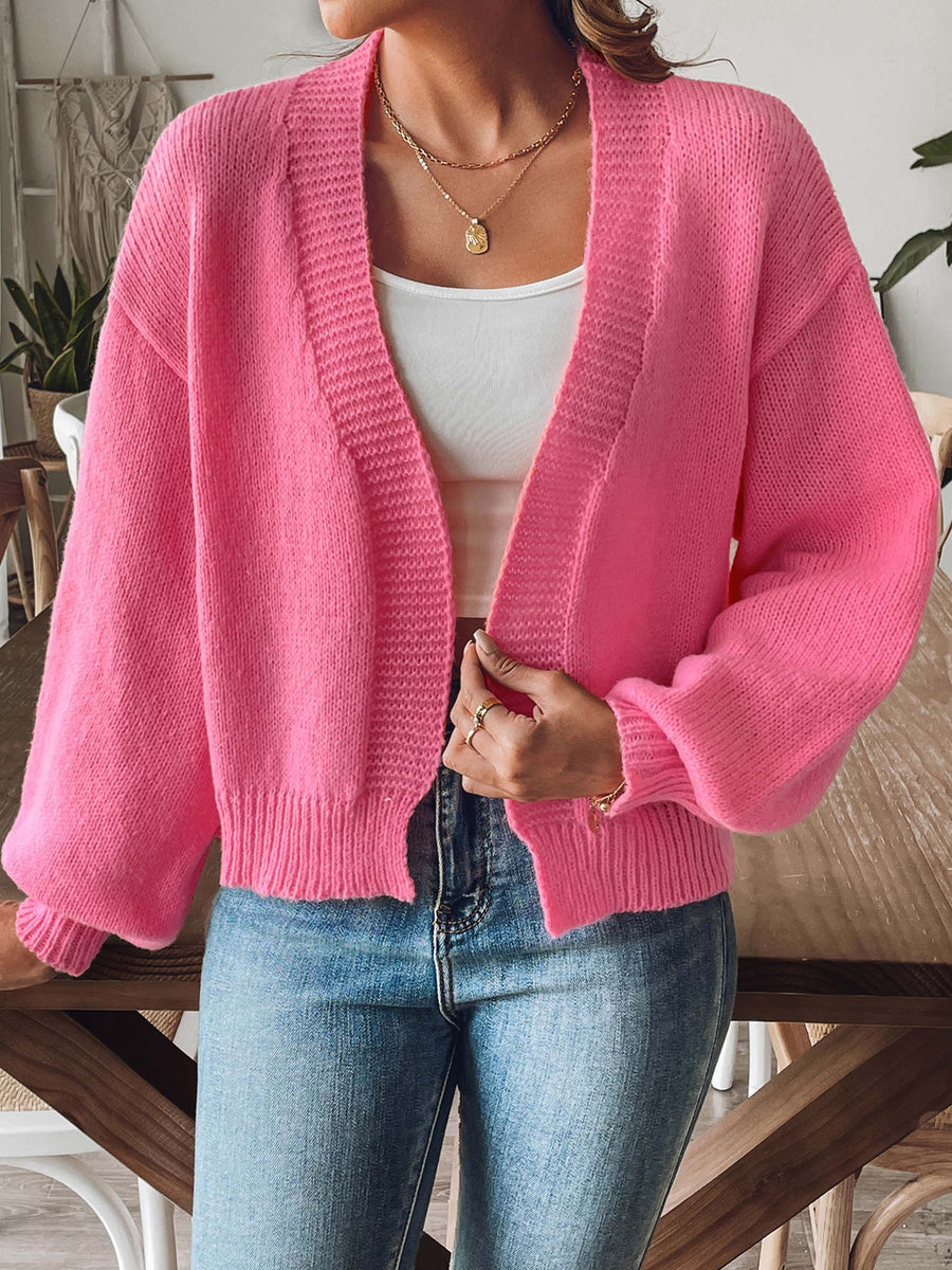 Pink balloon sleeve knit cardigan with ribbed cuffs and hem, open front.