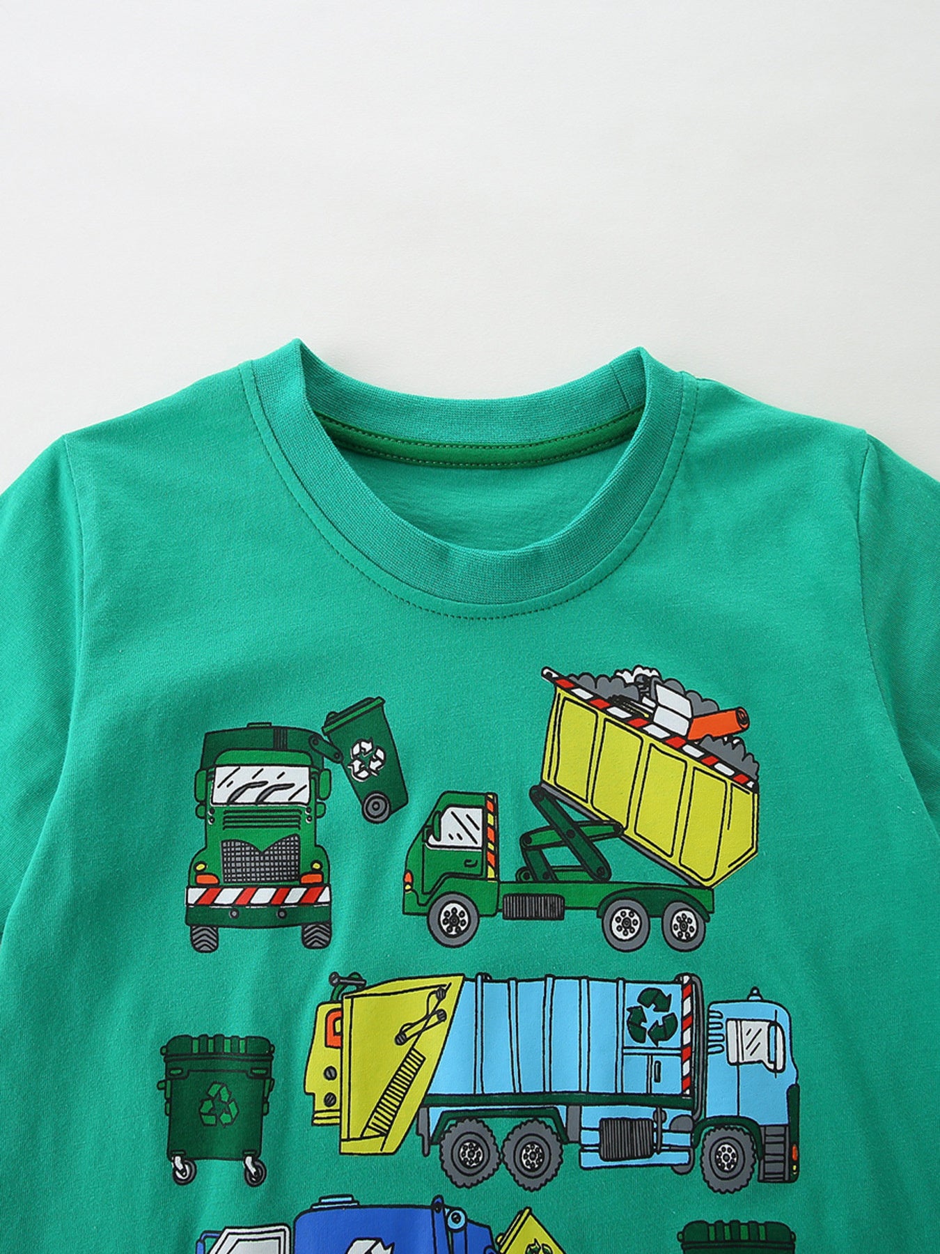 Green cotton toddler t-shirt with vehicle print and crew neck.