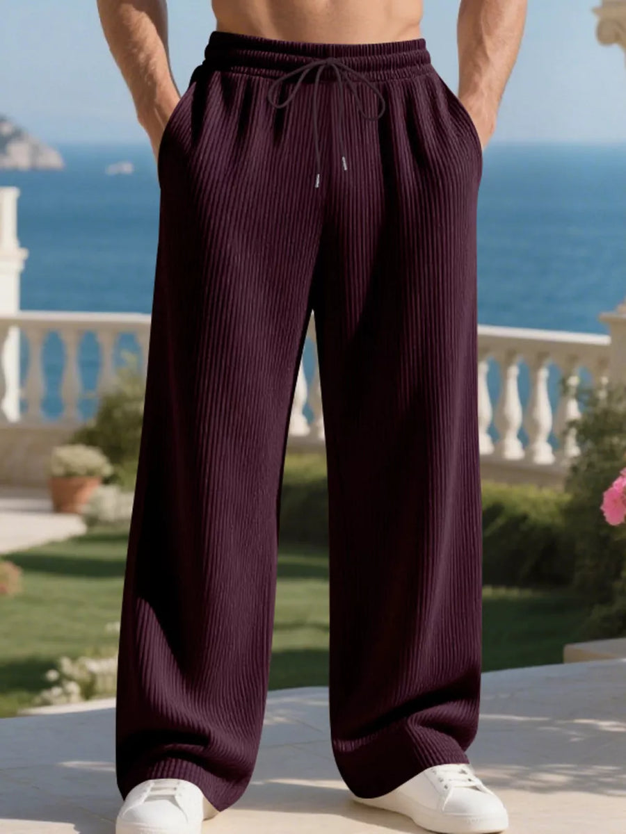 Wine red pleated drawstring sweatpants with a relaxed fit and wide leg.