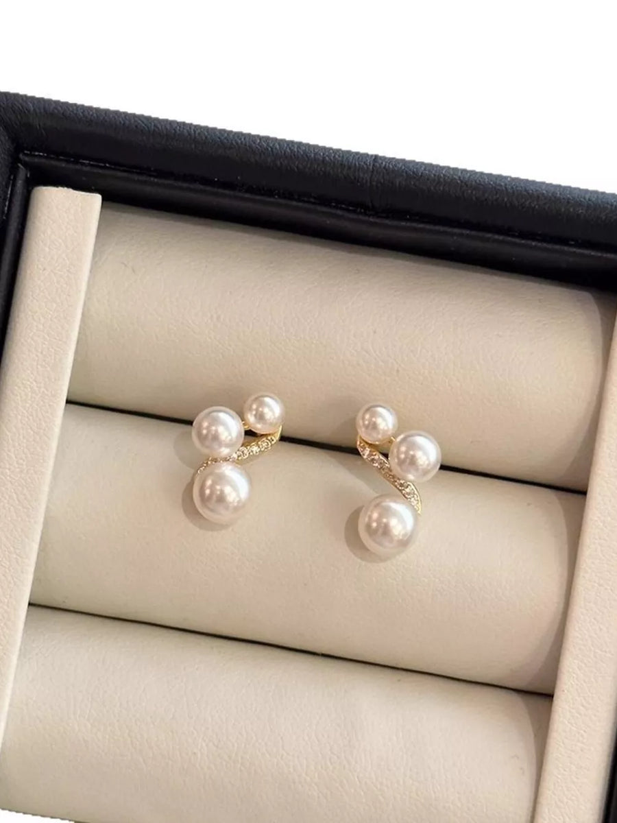Elegant pearl cluster earrings in gold with diamond accents.