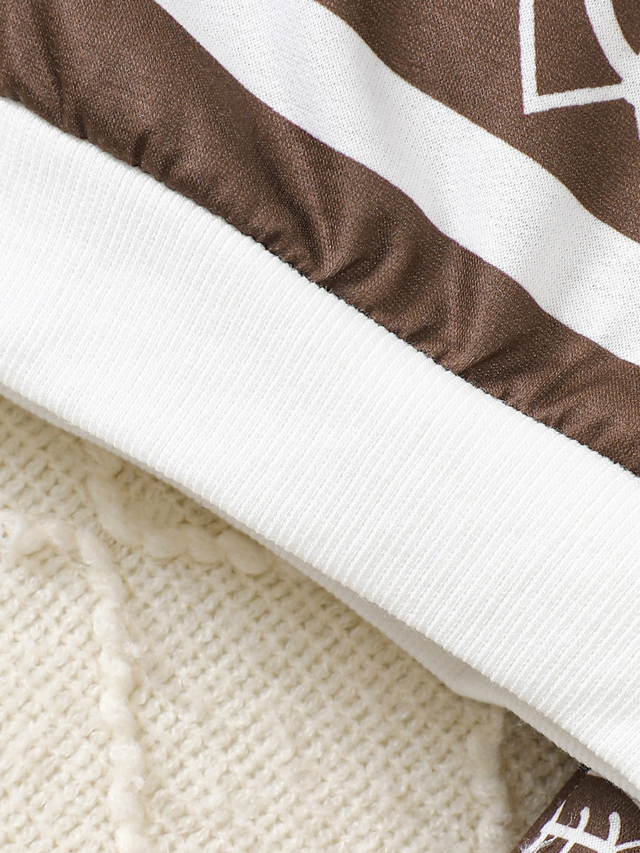 Baby top and pants set with brown and white football print and ribbed cuffs.