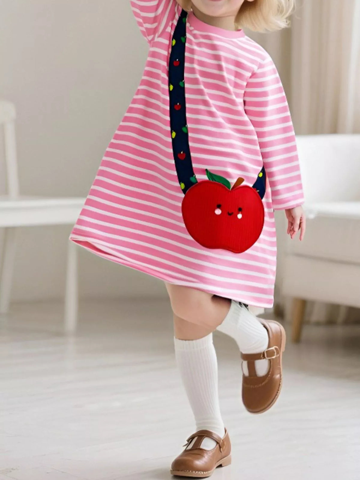 Baby girl's pink striped cotton dress with a red apple applique and crossbody strap.