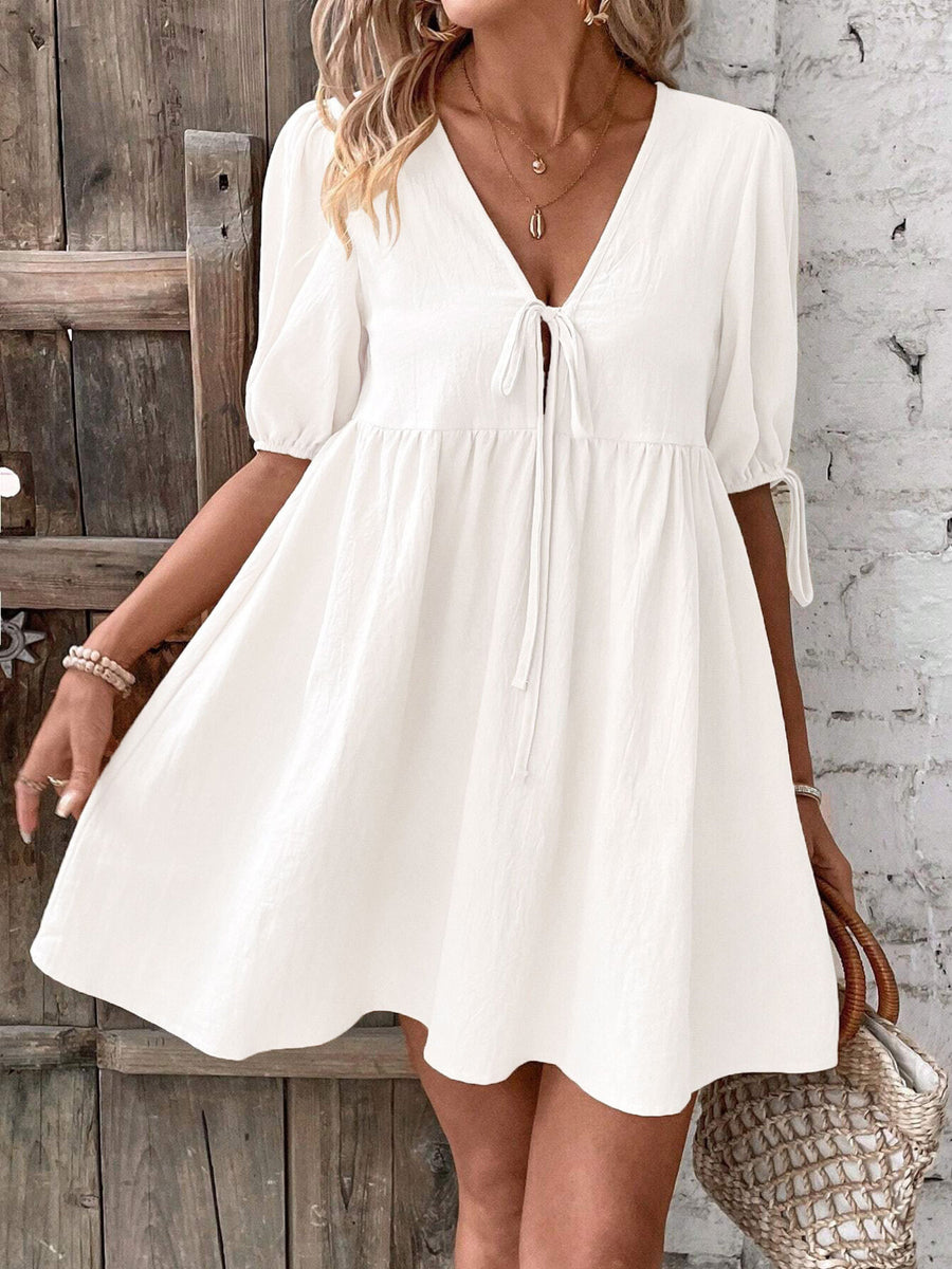 White tie front puff sleeve mini dress with adjustable tie details and a-line cut.