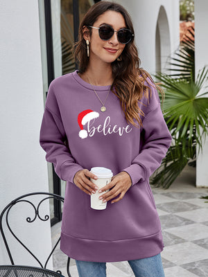 Dusty Purple Christmas graphic tunic sweatshirt with Santa hat and "Believe" text.