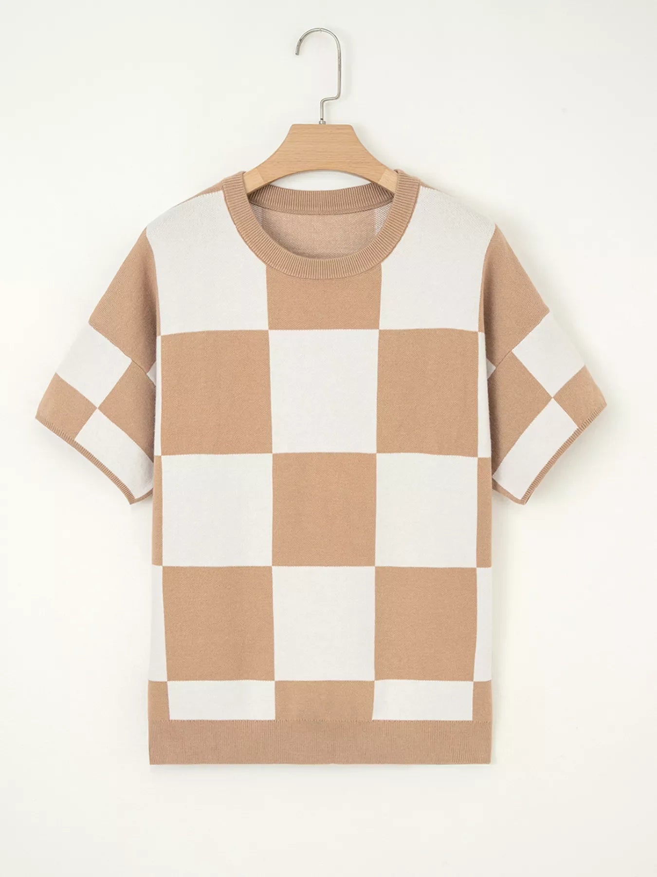 Drop shoulder sweater in camel and white checkerboard pattern with crew neck and short sleeves.