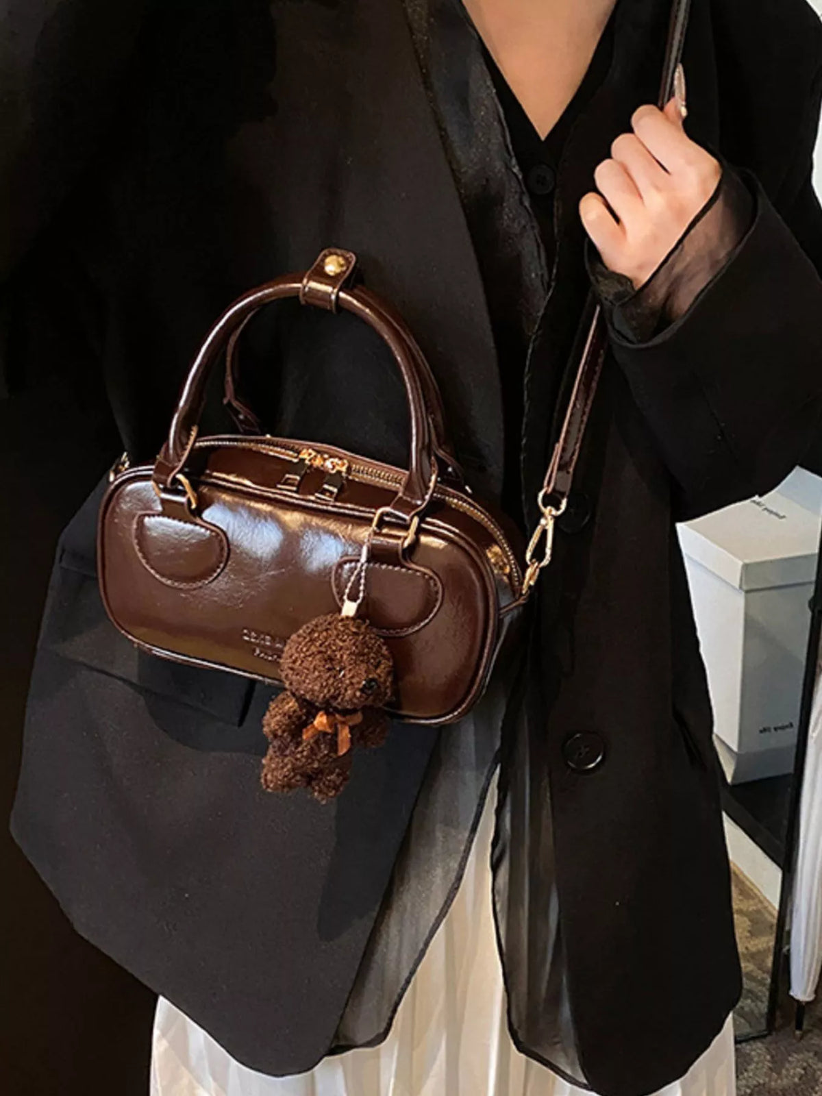 Chic mini crossbody bag in chocolate PU leather with teddy bear charm and top handle