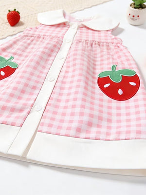 Pink gingham toddler dress with white collar, button front, and strawberry appliqué pockets.