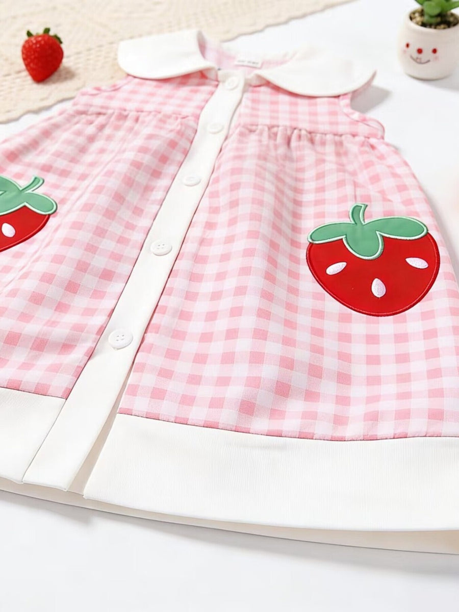 Pink gingham toddler dress with white collar, button front, and strawberry appliqué pockets.