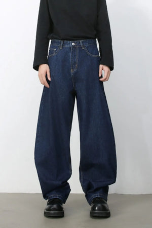 Faded baggy denim trousers in dark blue, featuring a wide leg and casual style.