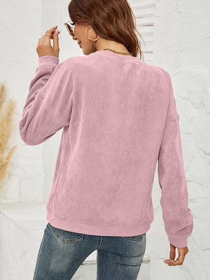 Textured corduroy crewneck sweatshirt in Dusty Pink with long sleeves.