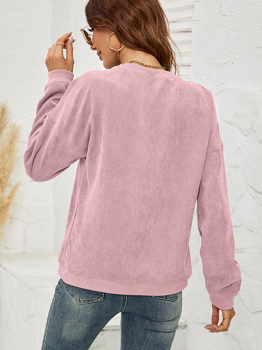 Textured corduroy crewneck sweatshirt in Dusty Pink with long sleeves.
