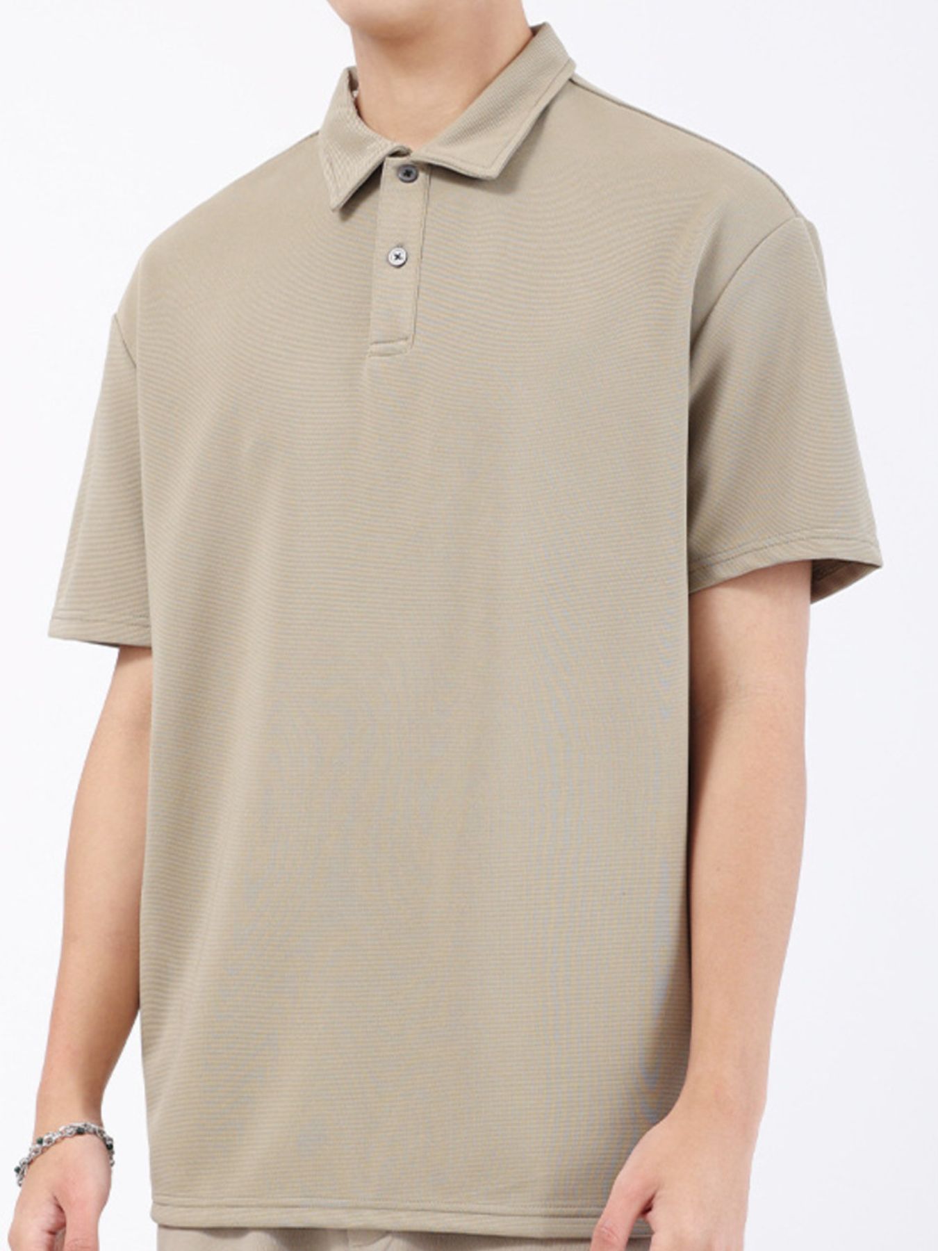 Khaki textured performance polo shirt with short sleeves and a two-button placket.