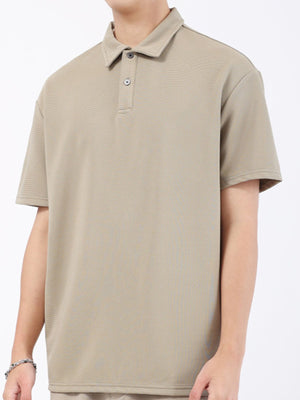 Khaki textured performance polo shirt with short sleeves and a two-button placket.