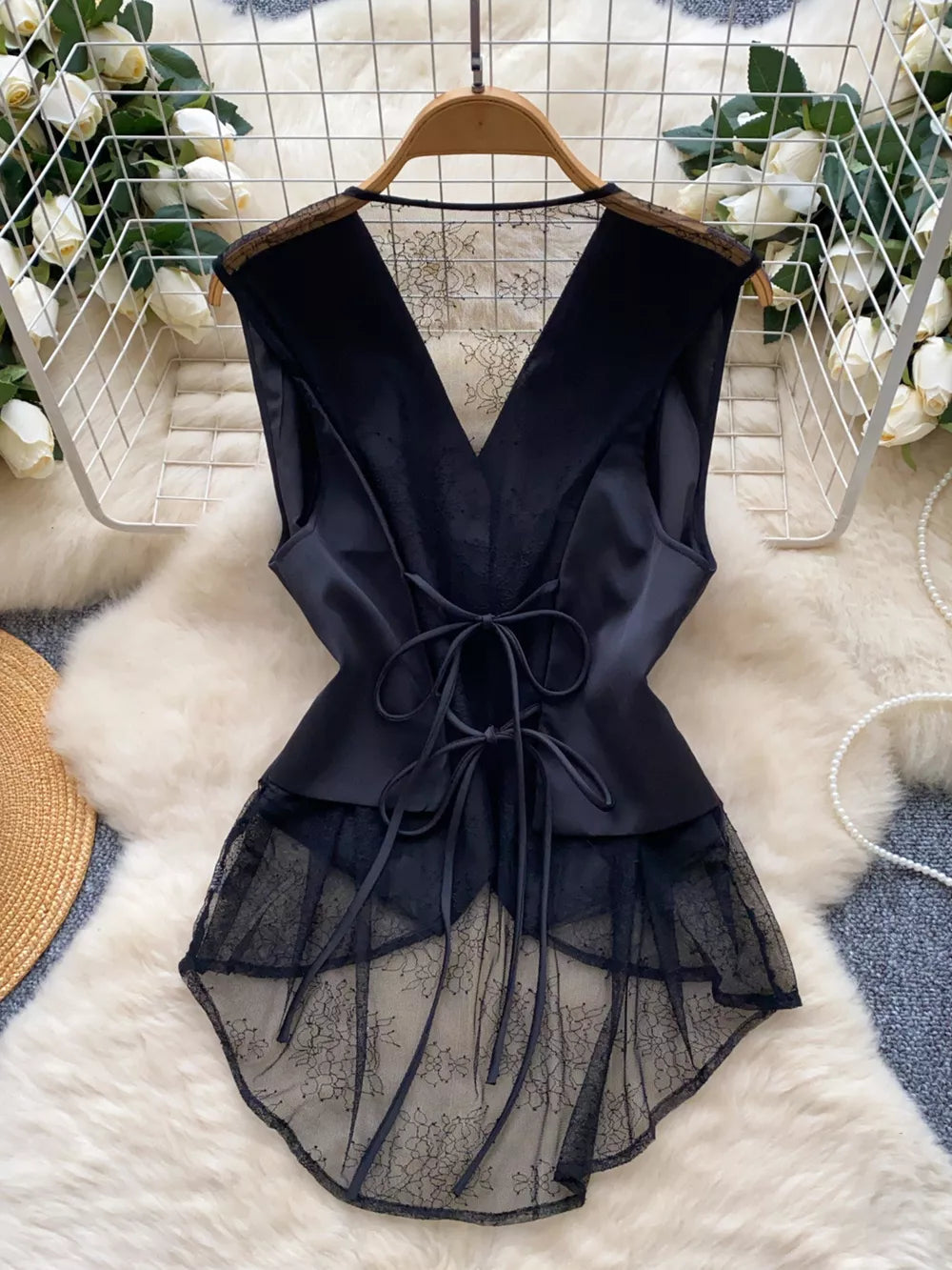 Black lace-embellished button-down vest coat with V-neck and tie waist detail.