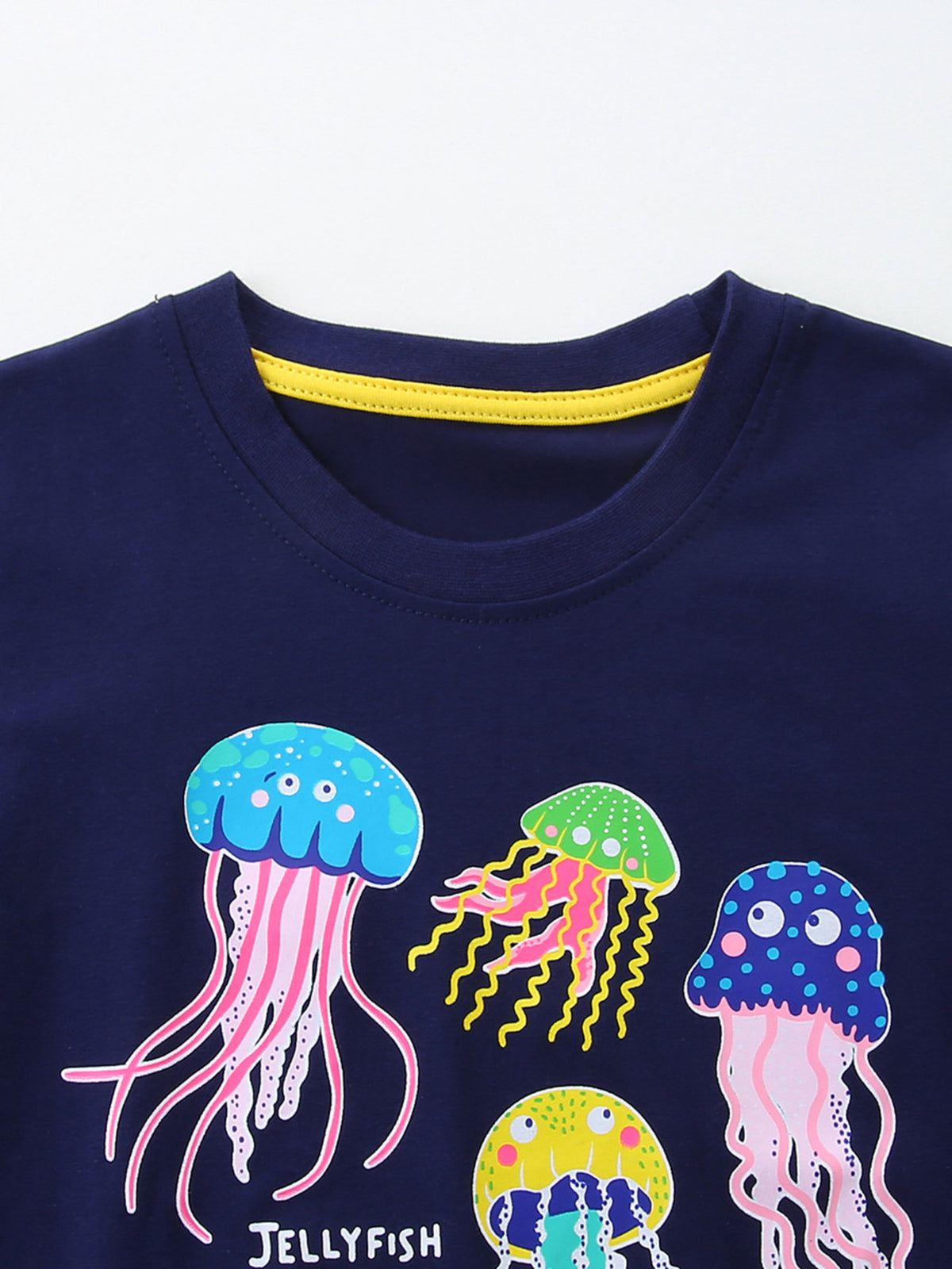 Navy cotton crew neck t-shirt with colorful jellyfish graphic and yellow trim.