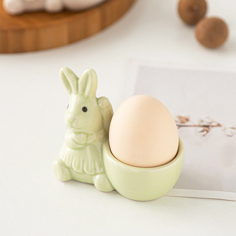 Light green ceramic bunny egg holder decor with an egg.
