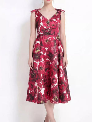 Floral midi dress with V-neck, bow shoulder details, and button accents.