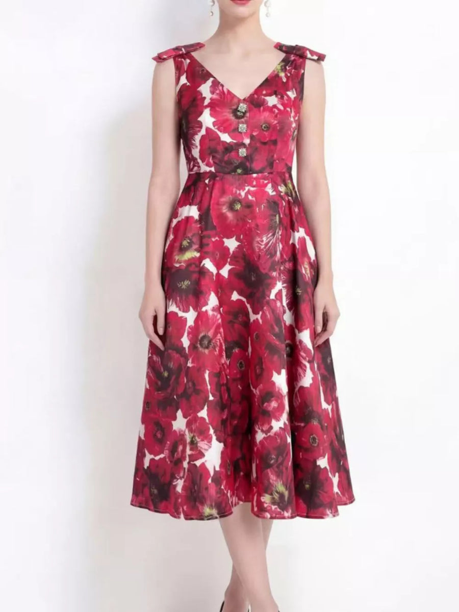 Floral midi dress with V-neck, bow shoulder details, and button accents.