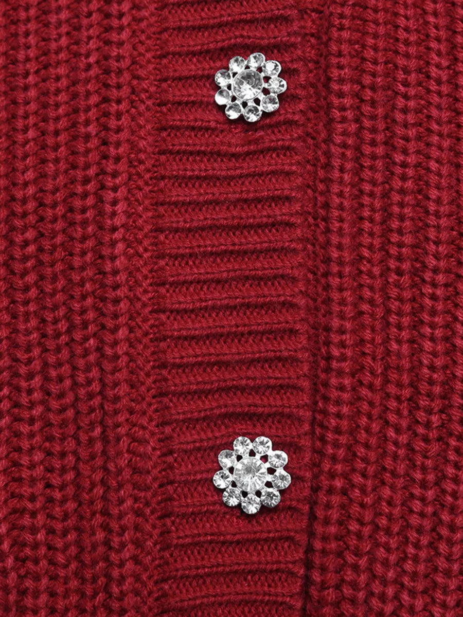 Red acrylic knit cardigan with pearl and rhinestone flower embellishments.