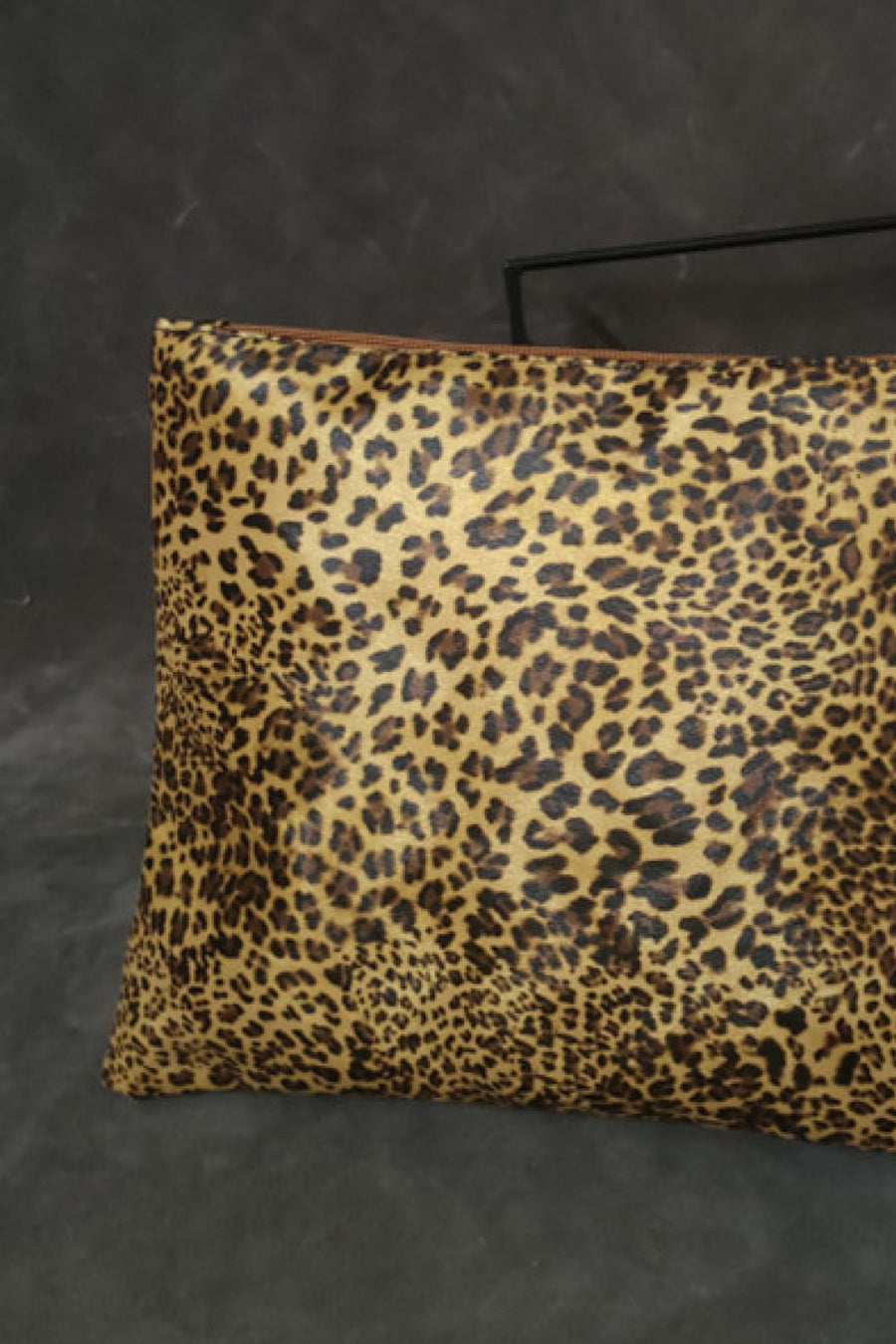 Leopard print zip-top clutch bag with brown zipper detail