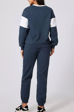 Navy active set sweatshirt with white color-block sleeves and matching joggers.