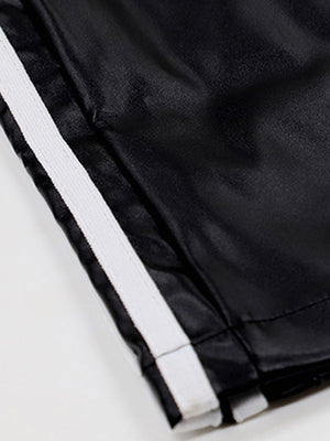 Black faux leather wide leg track pants with white side stripes and elastic waistband.