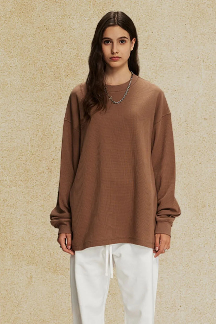 Brown oversized drop shoulder crewneck sweatshirt with crew neckline and long sleeves.