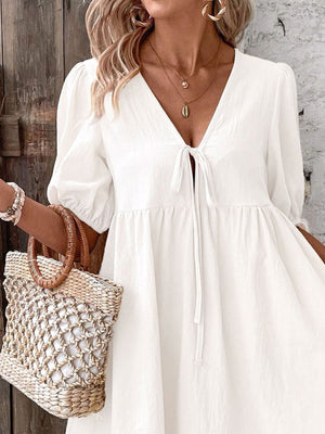 White tie front puff sleeve mini dress with a-line cut and v-neckline