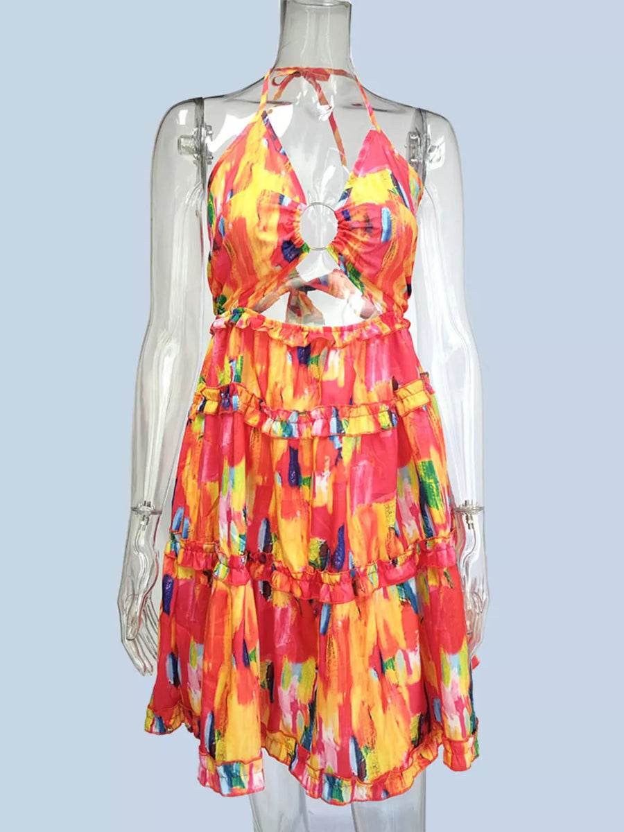 Abstract print halter mini dress with cutout and ruffles in yellow, red, and blue.