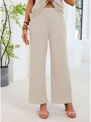 Beige waffle knit wide-leg pants with a comfortable fit.