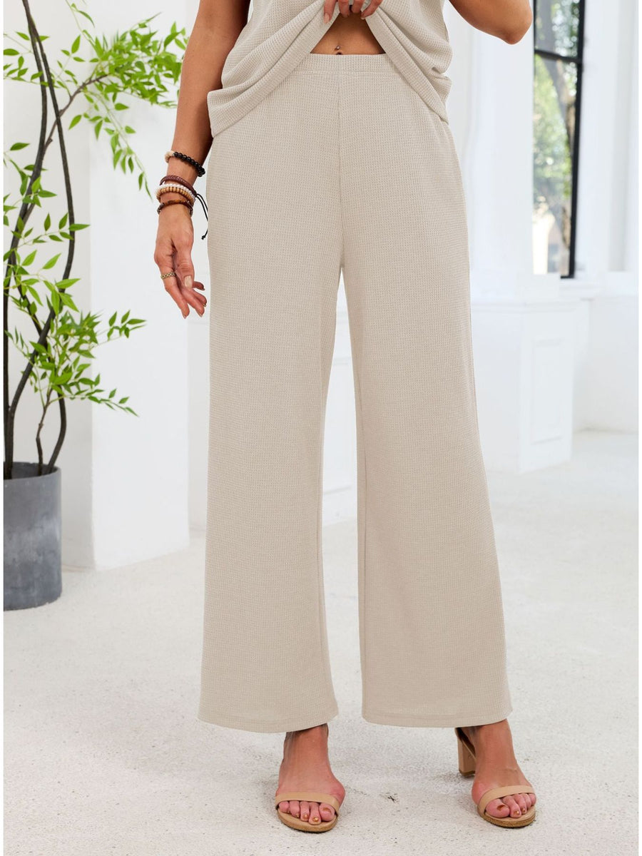 Beige waffle knit wide-leg pants with a comfortable fit.