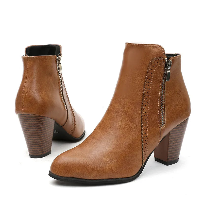 Caramel laser-cut detail block heel booties with side zippers and stacked heels.