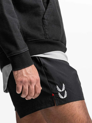 Black performance jogger shorts with white wing logo detail and red accent.