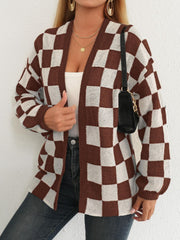 Checkerboard knit cardigan in brown and white with balloon sleeves and an open front.