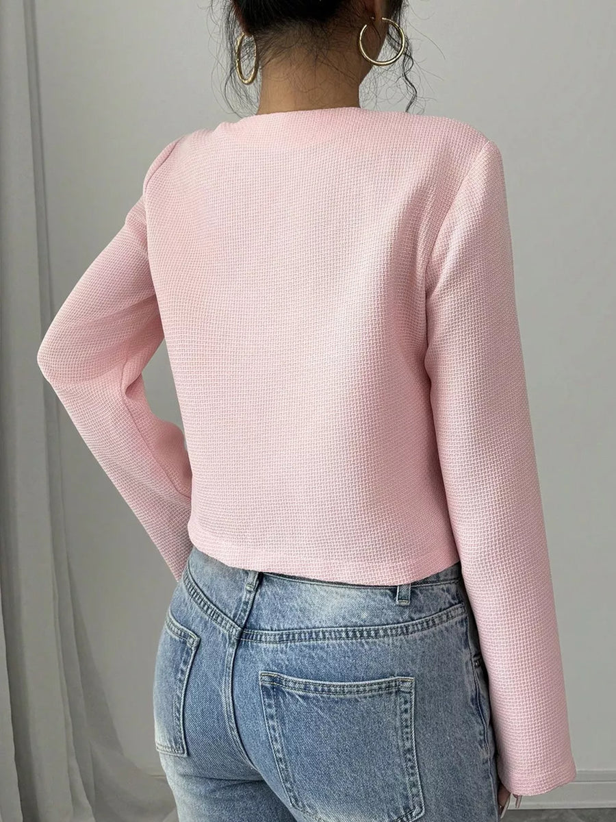 Pink textured long sleeve cropped top with crew neck