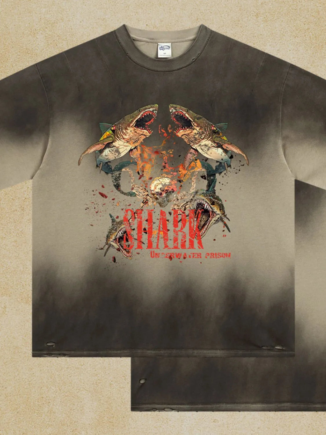 Distressed khaki t-shirt with a bold shark graphic and distressed details.
