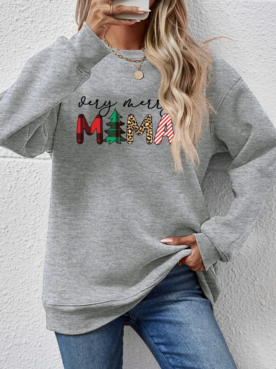 Gray crewneck sweater with "very merry mama" graphic in plaid, tree, leopard, and stripe patterns.