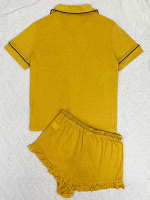 Yellow pajama set with short sleeves and ruffled shorts