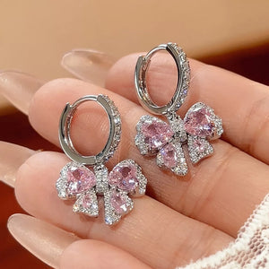 earrings in silver featuring bowknot design and drop fit