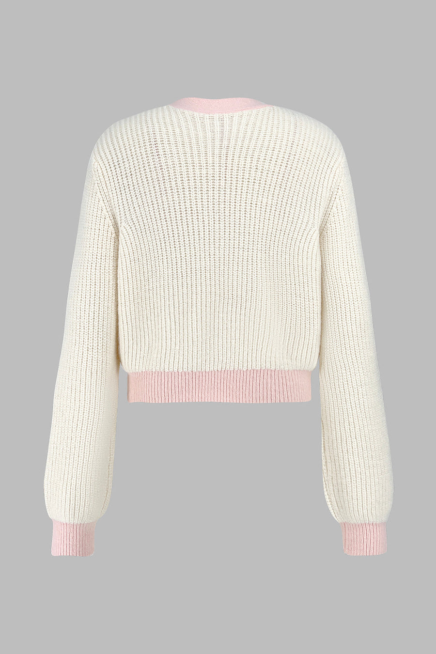 Cream acrylic cropped knit cardigan with contrast pink trim and cuffs.