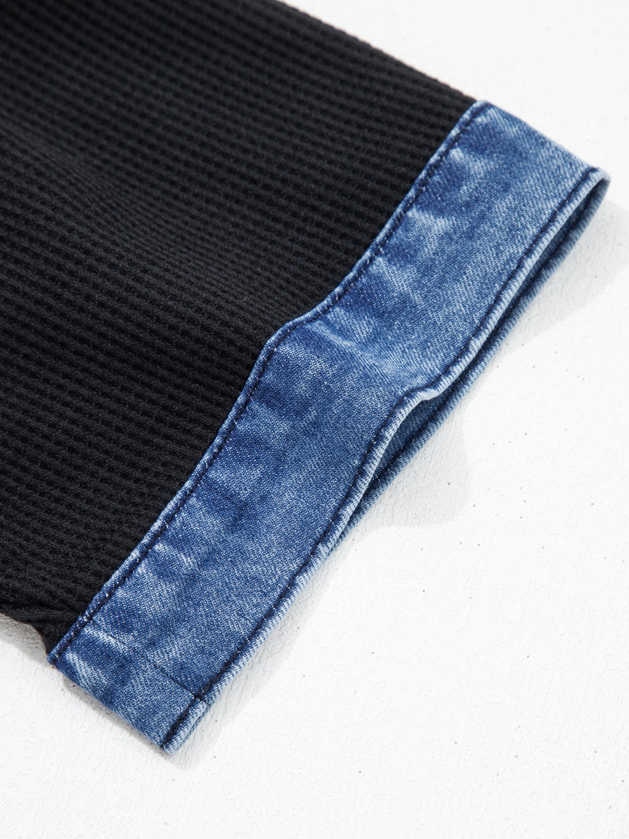 Black textured knit polo top with blue denim trim detail