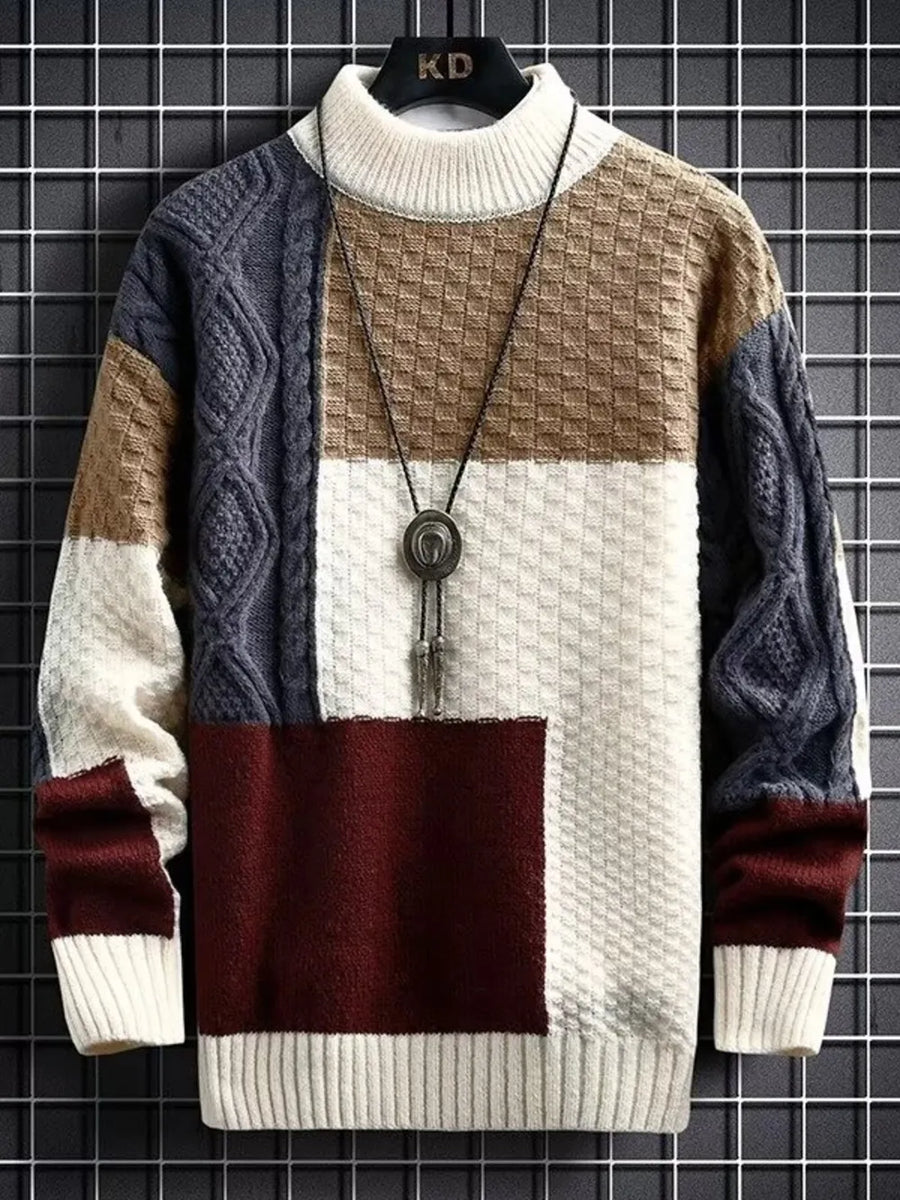 Men's multi-textured color block cable-knit pullover sweater with mock neck.