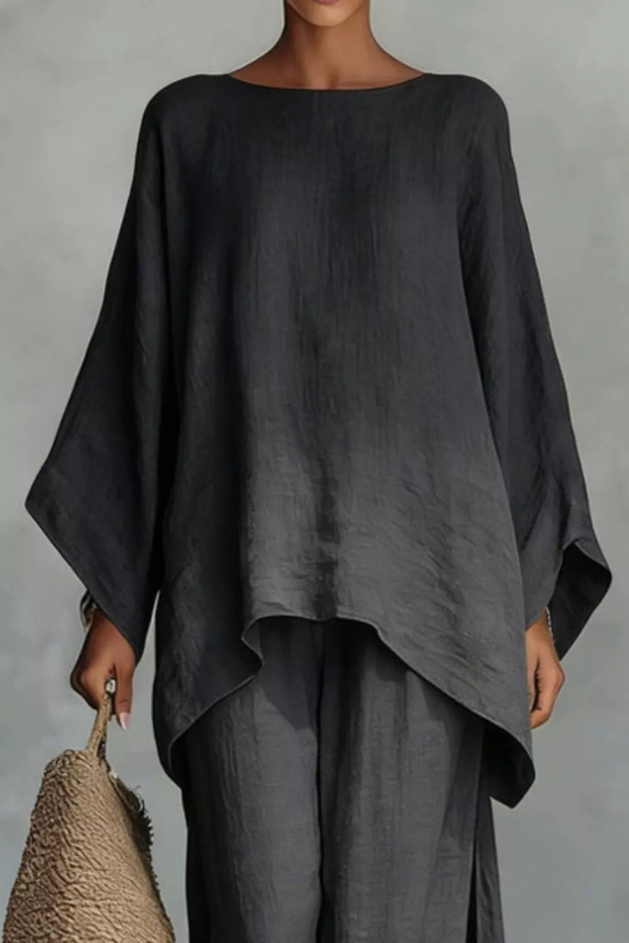 Black polyester two-piece set with flowing top and wide sleeves.