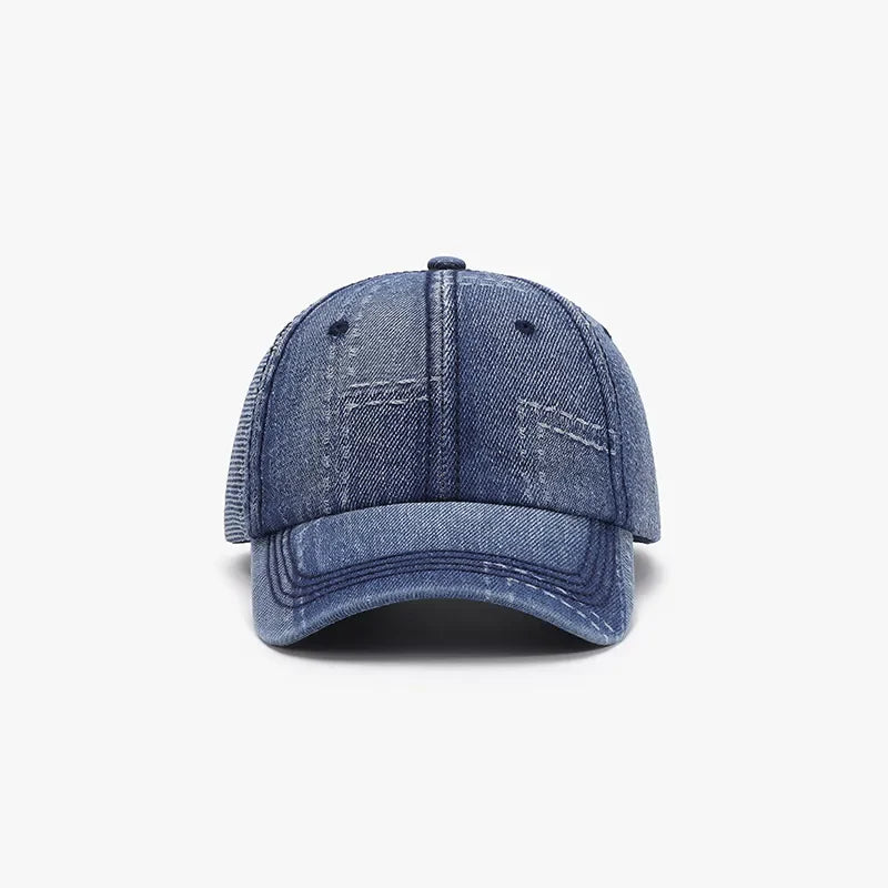Denim patchwork baseball cap with contrast stitching and mesh back panel.