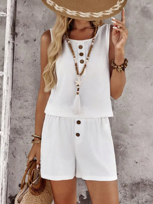 White cotton two-piece set with decorative buttons and a tassel detail.
