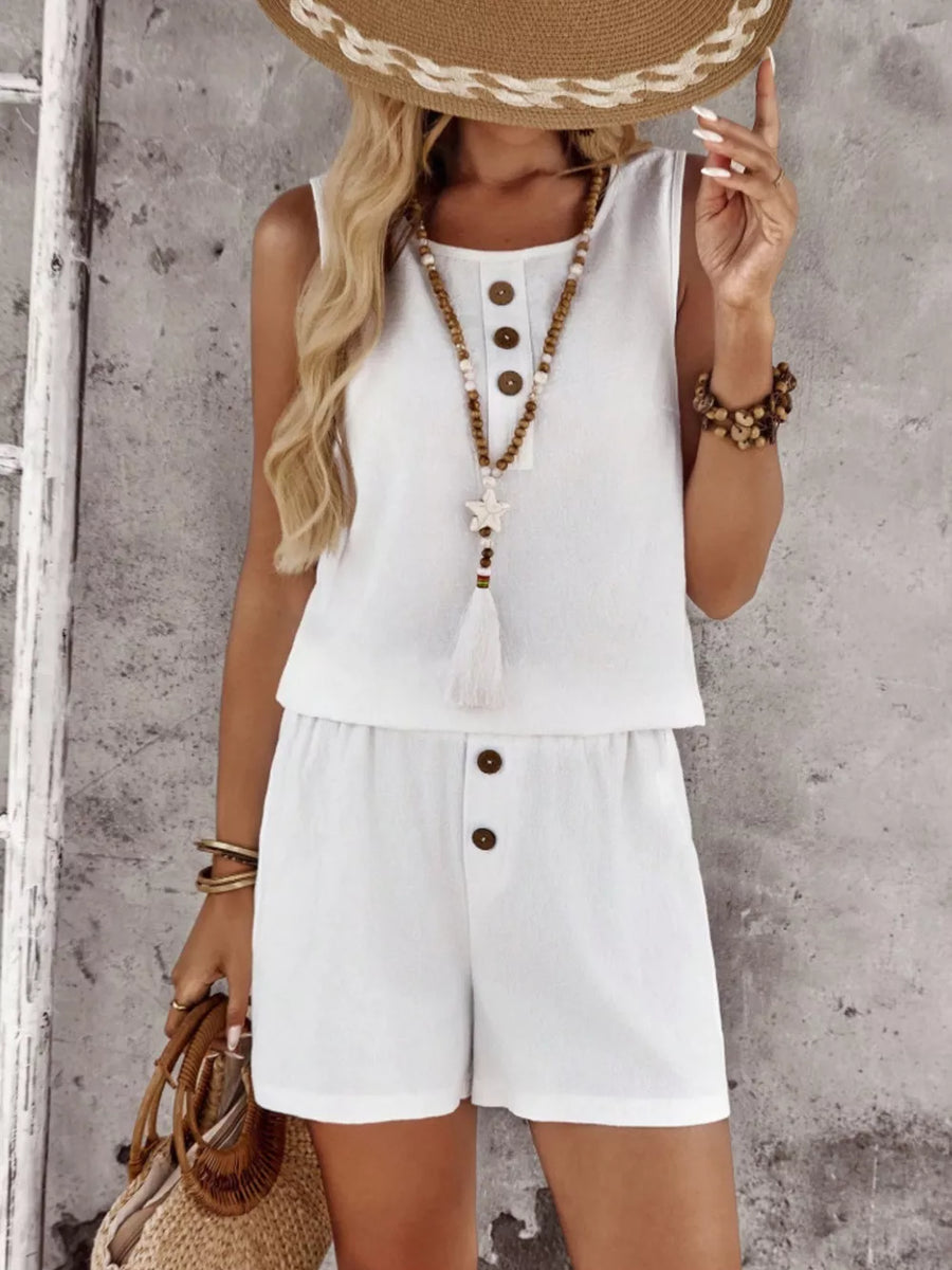 White cotton two-piece set with decorative buttons and a tassel detail.