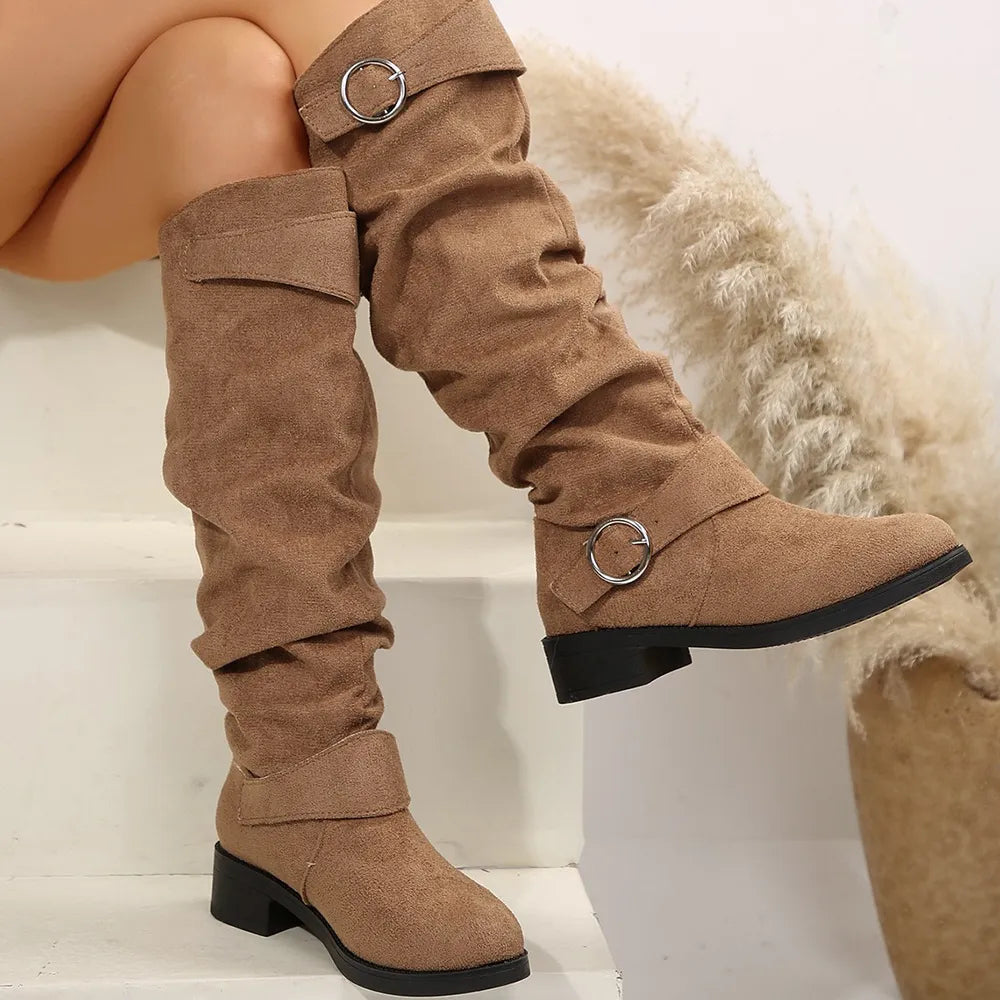Slouchy taupe knee-high boots with buckle detail and low heel.