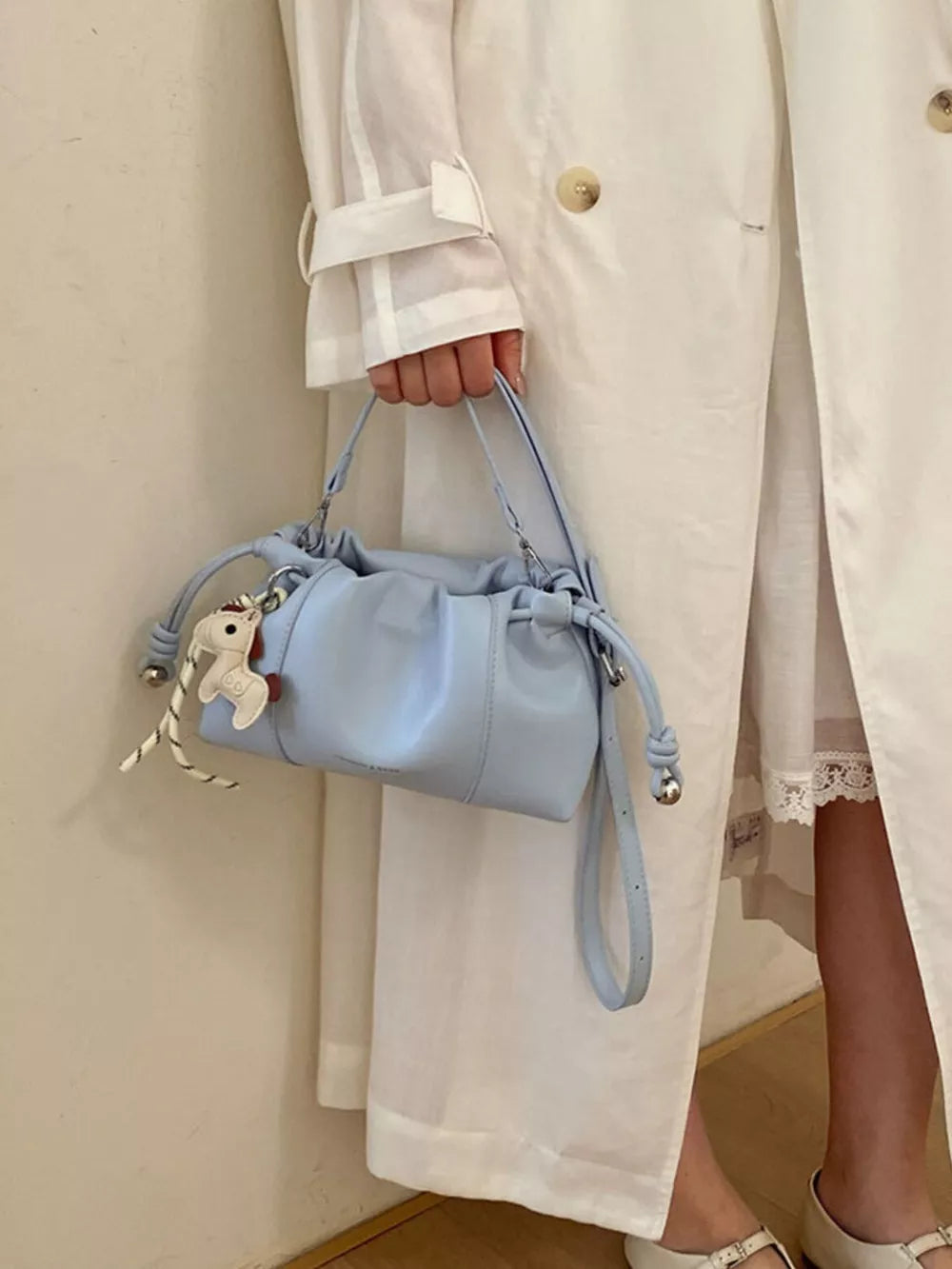 Drawstring Leather Crossbody Bag in Blue with drawstring closure
