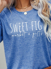 Cobalt blue graphic t-shirt with white "Sweet Fig market & gifts" text.